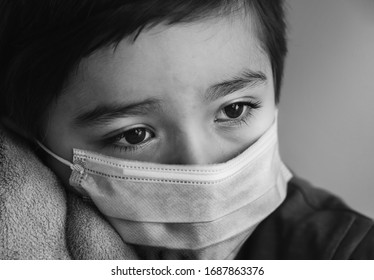 Close Up Kid Crying In Black And White Photo,Dramatic Portrait Child Wearing Medical Face Mask Looking Out Deep In Thought,Candid Sad Boy Tearing Stay At Home During Covid Lock Down, Social Distancing