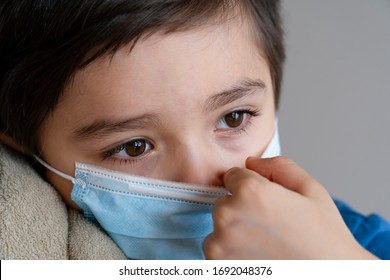 Close up Kid crying in black and white photo,Dramatic portrait child wearing medical face mask looking out deep in thought,Candid sad boy tearing stay at home during covid lock down, Social Distancing