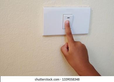 Close Up Finger’s Kid Is Turning On Or Turning Off The Light-switch.