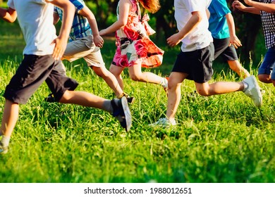 Close Up Of Kids Legs Run Down On The Grass Field