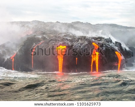 Close up of Kilauea Volcano, Hawaii Volcanoes National Park, also known Kilauea Smile because from 2016 seems to smile, erupting lava into Pacific Ocean, Big Island. Scenic sea view from the boat.