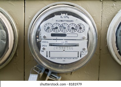 A close up of a kilowatt hour single stator power company meter.
