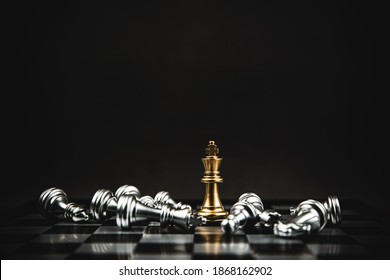 Close up king chess standing on chess board with falling chess concepts of business team and leadership strategy and organization management.