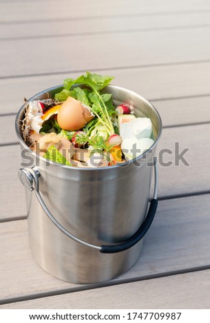 Close Up of Kitchen Counter Compost Bin with Food Scraps 