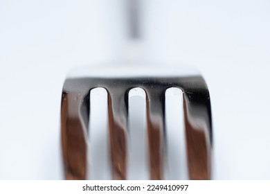 Close up of kitchen forks on white background with selective focus - Shutterstock ID 2249410997