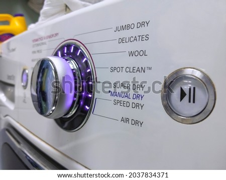 Close up of a knob on a clothing dryer control panel