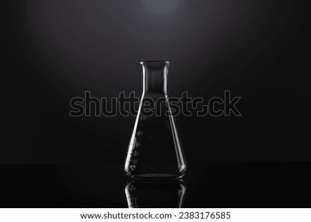 Close up of laboratory beaker and copy space on black background. Laboratory, science, research and chemistry concept.