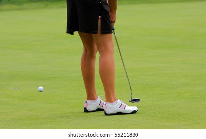 Close Up Of Lady Golfer Putting