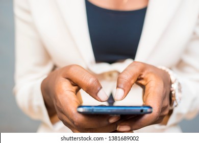 close up of a lady's typing on her phone with both hands