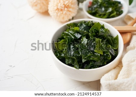 close up laminaria (Kelp) seaweed in bowl on white table background                        with copy space                                                    