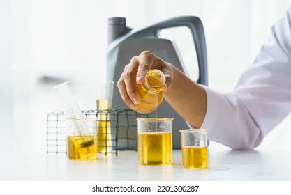 Close up lap worker test and pours car engine oil quality test, checking and compare color difference. - Powered by Shutterstock