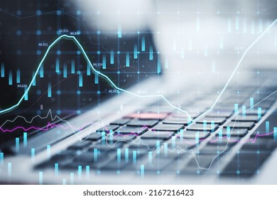 Close Up Of Laptop With Abstract Glowing Forex Graph On Blurry Background With Candlestick. Invest, Trade And Broker Concept. Double Exposure