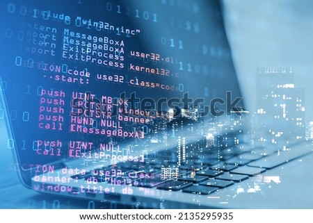 Close up of laptop with abstract html code on creative city background. Coding and programming concept. Double exposure