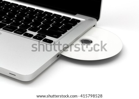 Close up Laptop with Blank DVD.  Isolated on white background