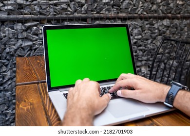 Close Up Laptop With Chroma Key Green Screen. Male Hands Typing On Keyboard.