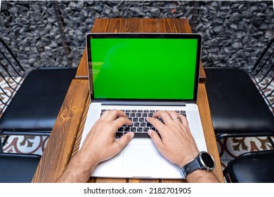 Close Up Laptop With Chroma Key Green Screen. Male Hands Typing On Keyboard.