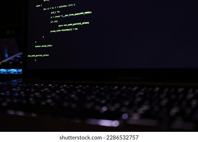 a close up laptop with code on screen with selective focus.