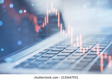 Close up of laptop computer with abstract falling candlestick forex chart on blurry background. Crisis, workplace and stock concept. Double exposure