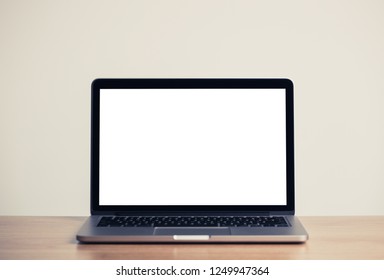 Close Up Laptop Computer On Top Of Office Table With Empty White Screen, Emphasizing Copy Space.