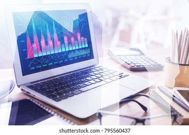 Close Up Of Laptop With Digital Business Graph On Screen Placed On Blurry Office Desktop. Accounting And Project Concept. Double Exposure 