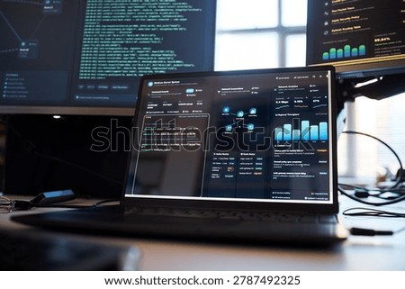 Close up of laptop displaying code, network analytics, cybersecurity dashboard in IT workspace. Supporting cloud security, DevOps, data monitoring, software marketing use