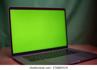 Close Up Laptop With Green Screen On Table In Work Space Concept.