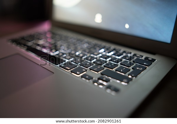 Close up of laptop keyboard colorful neon\
illumination, backlit\
keyboard.