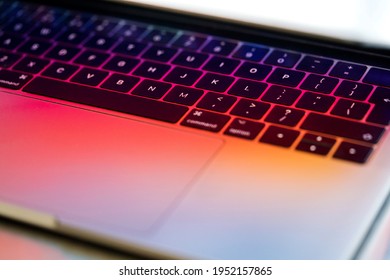 Close up of laptop partially open with colorful prism light and keyboard - Shutterstock ID 1952157865