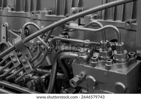 Close up of a large engine with many pipes and valves. Concept of complexity and intricacy, as the various components work together to power the engine.