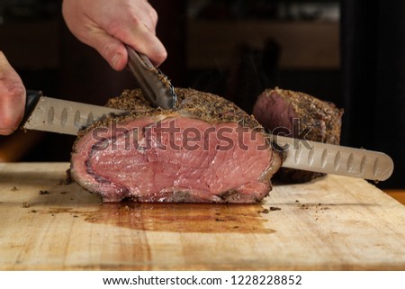 Close up of a large Prime rib roast being sliced for dinner service