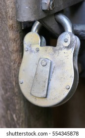 Close up of a large silver padlock for a gate