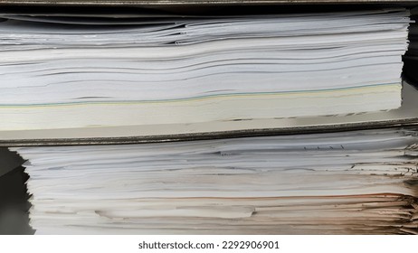 Close up large stack pile of file folders with paper documents in the office, business documents, messy, selective focus, filing, hardcopy