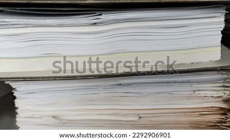 Close up large stack pile of file folders with paper documents in the office, business documents, messy, selective focus, filing, hardcopy