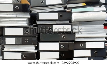 Close up large stack pile of file folders with paper documents in the office, business documents, messy, selective focus, filing, hardcopy