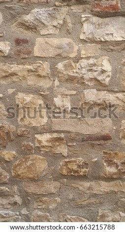 Close up of large stone wall with different types, sizes and shape of stones