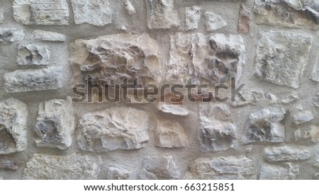 Close up of large stone wall with different types, sizes and shape of stones