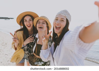 Close up laughing female friends young women 20s wearing straw hat summer clothes hang out together do selfie shot on mobile cell phone outdoor on sea beach background People vacation journey concept - Powered by Shutterstock