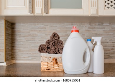 Close Up A Laundry Basket Full With Fresh Clean Towels Near Bottle Of Liquid Detergent Powder Wash, Bleach, Spray On Vintage Stone Background.