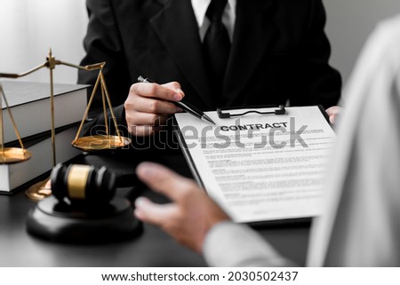 Close up of a lawyer advising client making contract, make a deal agreement, Judge gavel, brass scale, law firm office, business people discuss document legal, law, and justice advice service.