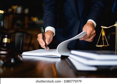 Close up lawyer businessman working or reading lawbook in office workplace for consultant lawyer concept. - Shutterstock ID 1080775979