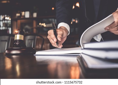 Close up lawyer businessman working or reading lawbook in office workplace for consultant lawyer concept.