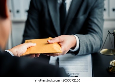 Close up of Lawyer or businessmen getting graft from a client, make a deal agreement corruption, Judge gavel, brass scale, law firm office, dishonest, law and justice advice service. - Shutterstock ID 2053072166