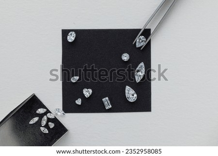 Close up layout of different cut diamonds top view on black background with copy space.