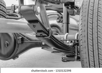 Close Up Leaf Spring Suspension Of Pick Up Car Truck Black And White Concept.