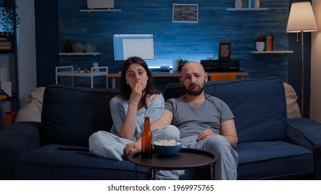 Close Up Of Leftover Food On Table In Empty Messy Living Room, Bottle Of Beer And Napkins On Blue Sofa. Unorganized Apartment Of Alone Woman With Sever Depresion Having Trash Rubbish With No People In