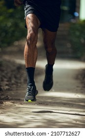 Close Up Of Legs Of Black Guy Running With Black Running Shoes In Park In Barcelona City