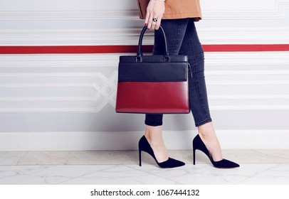 Close Up Legs Fashion Woman In Heel Shoes With Big Handbag In Hand. Autumn Trench Coat Outfit