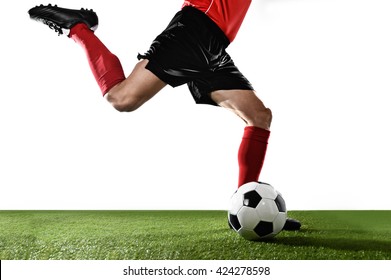 close up legs of football player in red socks and black shoes running and kicking the ball in free kick action playing isolated on white background