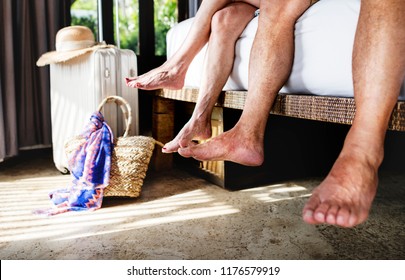 Close Up Of Legs Of A Senior Couple In A Bedroom