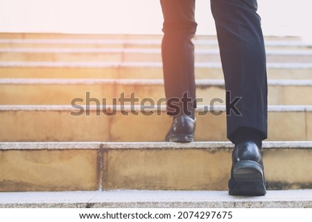 Image, Stock Photo A man climbs up a snow-covered mountain